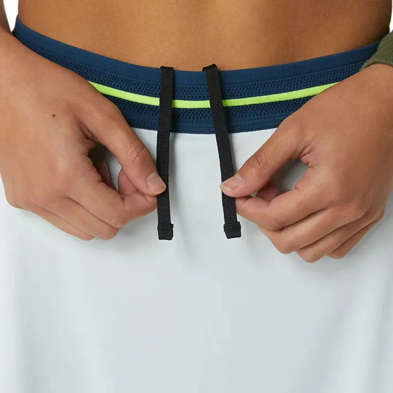 prenda deportiva mujer asics match azul con detalles navy y verde lima